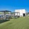a grassy area with tables and chairs