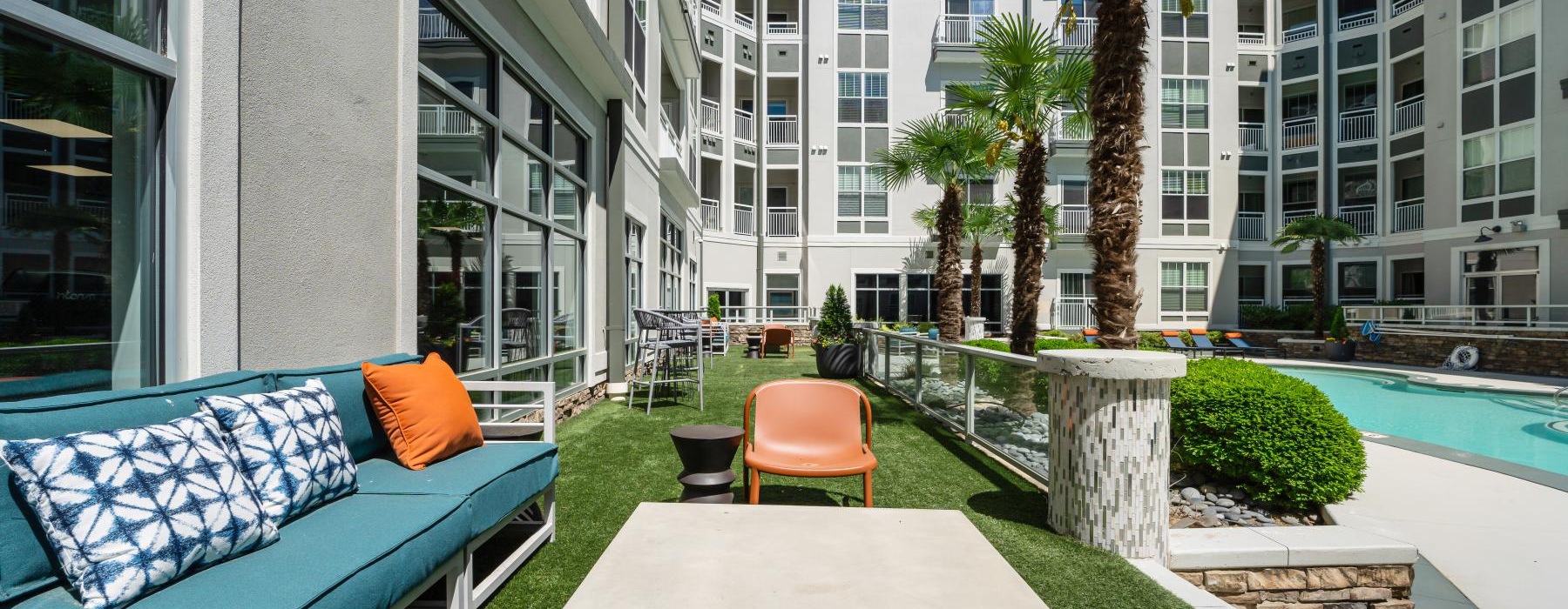 a courtyard with a couch and chairs